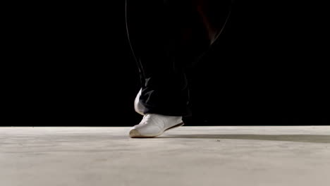 Cool-young-break-dancer-dancing-on-black-background