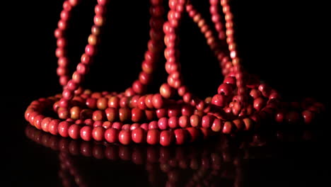 Red-prayer-beads-falling-on-black-background
