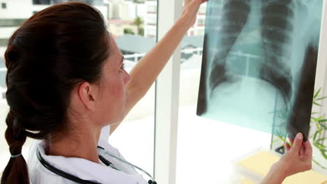 Pretty-nurse-holding-up-xray-to-window