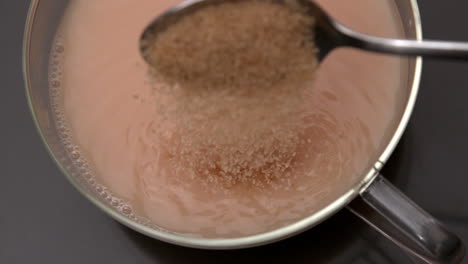 Teaspoon-pouring-sugar-into-cup-of-tea