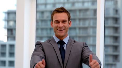 Smiling-handsome-businessman-showing-thumbs-up