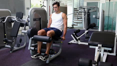 Fit-man-exercising-his-legs-on-weight-machine