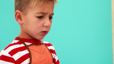 Cute-little-boy-painting-at-table-in-classroom