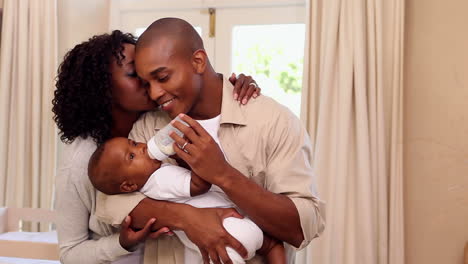 Happy-father-feeding-baby-son-with-mother