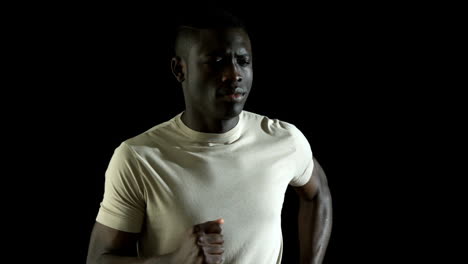 Handsome-man-jogging-against-black-background