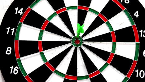 Green-dart-hitting-the-bullseye-on-white-background