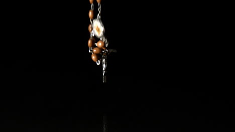 Crucifix-falling-on-black-background