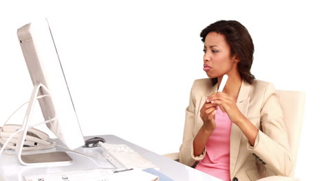 Businesswoman-filing-her-nails-at-her-desk