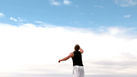 Martial-arts-expert-practicing-on-the-beach