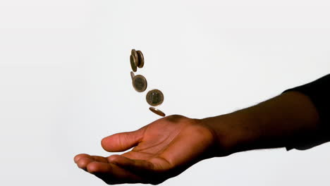 Businessman-catching-falling-coins-in-hand