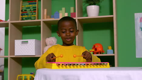 Cute-little-boy-playing-xylophone-in-classroom