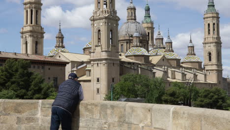 Man-Looking-At-The-Cathedral-Basilica-of-Our-Lady-of-the-Pillar-In-Zaragoza,-Spain