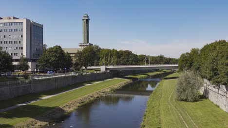 Most-Pionyru-bridge,-Ostravice-river-and-tower-of-Nova-radnice-town-hall-in-background-in-Ostrava,-Czech-Republic