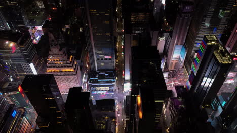 Illuminated-streets-of-the-Times-square,-night-in-New-York---Aerial-tracking-shot