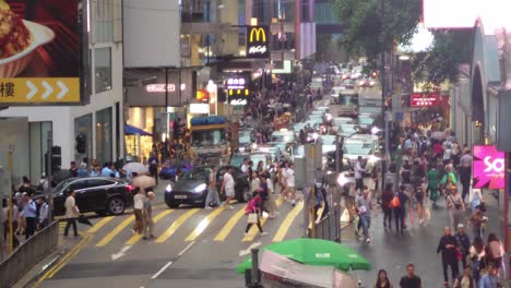 Profile-view-of-busy-crowded-Queen's-road-during-evening-in-Hong-Kong,-China