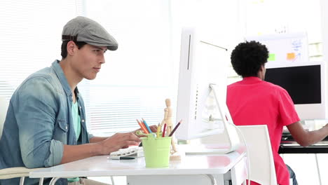 Creative-worker-working-on-his-computer-at-desk