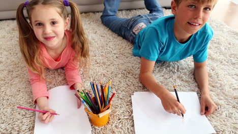 Happy-siblings-colouring-on-the-rug