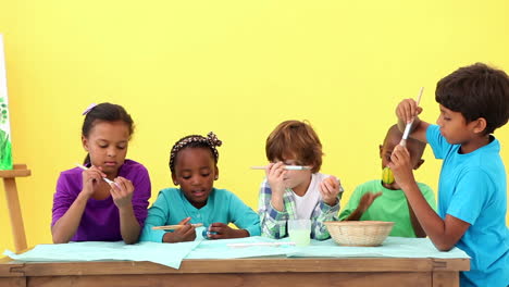 Cute-pupils-painting-eggs-for-easter