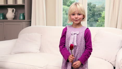Cute-little-girl-holding-a-red-rose