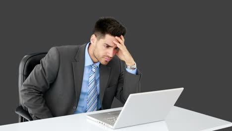 Young-businessman-working-at-his-desk