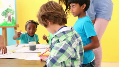 Cute-pupils-painting-pictures-with-teacher