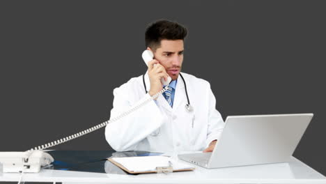 Young-doctor-working-at-his-desk