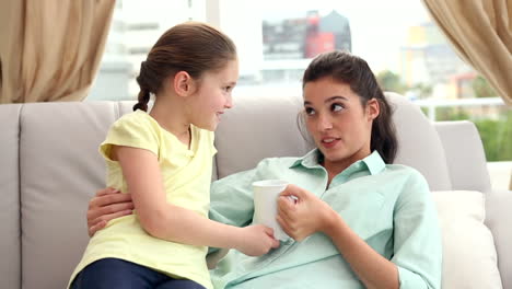 Happy-mother-and-daughter-on-the-couch