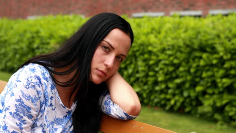 Sad-brunette-thinking-on-bench-in-the-park