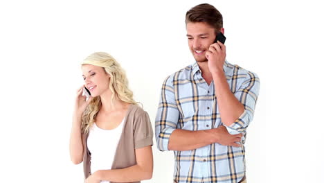 Attractive-young-couple-talking-on-phones
