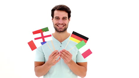 Handsome-young-man-showing-flags