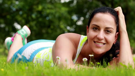 Pretty-brunette-lying-down-on-the-grass