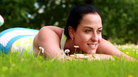 Pretty-brunette-lying-down-on-the-grass