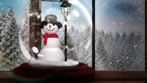Snow-globe-on-windowsill-looking-out-to-snowy-forest