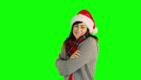 Woman-in-santa-hat-and-warm-clothing-blowing-over-hands-