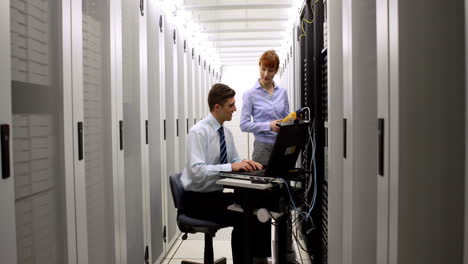 Technicians-using-digital-cable-analyzer-on-server-