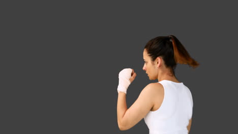 Fit-brunette-punching-with-bandaged-fists