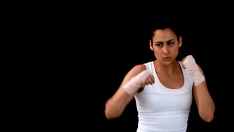 Fit-brunette-punching-with-bandaged-fists