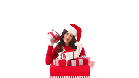 Disappointed-festive-brunette-looking-at-gifts