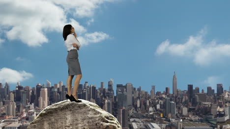 Businessman-and-woman-standing-on-rocks-looking-out