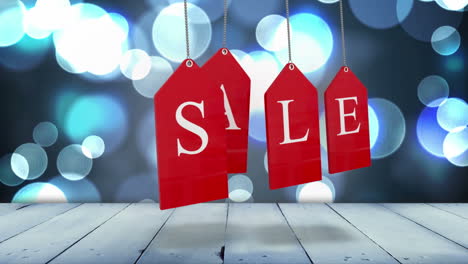 Red-sale-tags-hanging-against-glowing-background