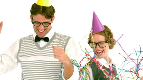 In-slow-motion-excited-geeky-hipster-couple-looking-at-confetti-