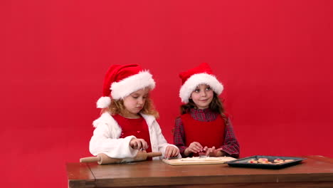 Cute-festive-sisters-making-christmas-cookies