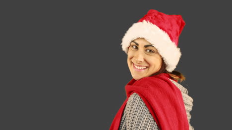 Girl-in-santa-hat-and-warm-clothing-blowing-over-hands