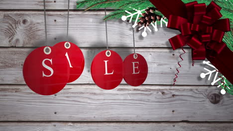 Red-sale-tags-hanging-against-wood-with-festive-decorations