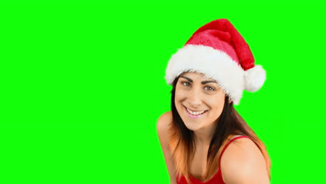 Pretty-girl-in-santa-hat-blowing-over-hands
