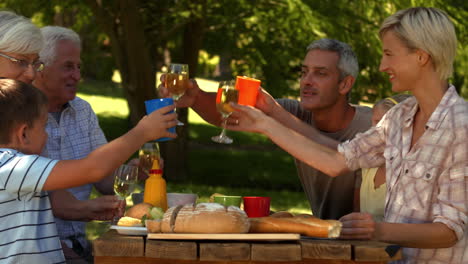 Glückliche-Familie-Beim-Essen-Im-Park