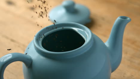 Loose-tea-pouring-into-blue-teapot