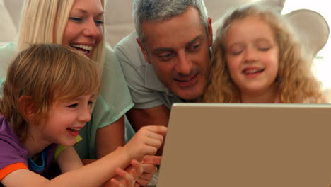 Happy-family-using-laptop-together