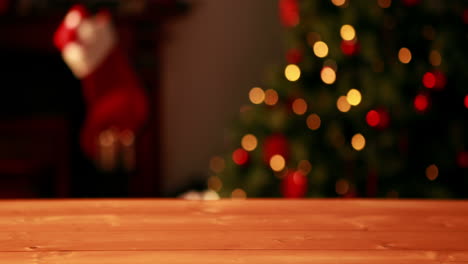 Empty-table-against-blinking-lights-on-christmas-tree