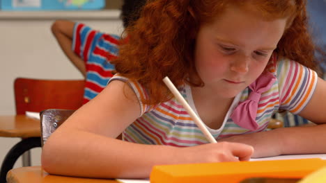 Schoolgirl-smiling-at-camera-in-class